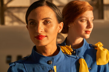 Smiling beautiful stewardesses in the evening sunlight