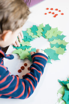 Little boy making Christmas decoration craft