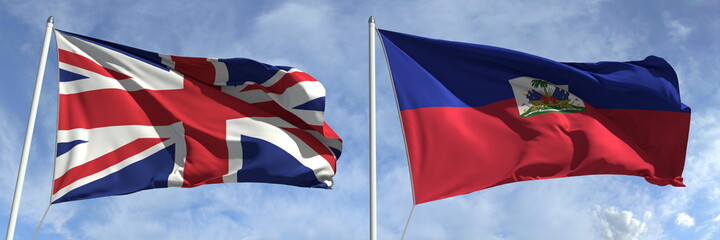 Naklejka premium Flags of the United Kingdom and Haiti on flagpoles. 3d rendering