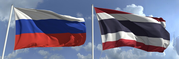 Flying flags of Russia and Thailand on sky background, 3d rendering