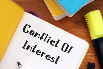 Conflict Of Interest sign on the piece of paper.