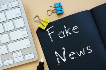 Business concept about Fake News with phrase on the page.