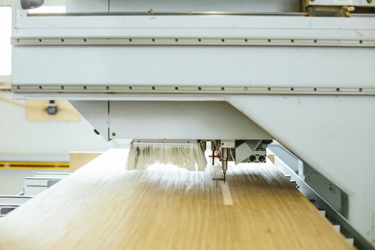 CNC machine drilling holes in wood