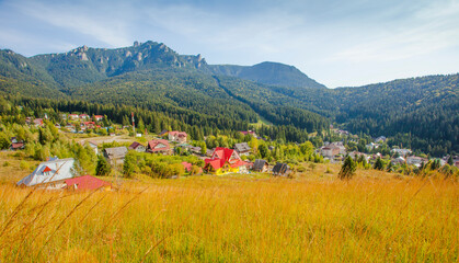 Durau mountain resort in Romanian Carpathians. Ceahlau peak in background. autumn landscape