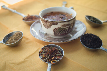 Tea time - a cup of fresh herbal tea and variety of natural tea tastes