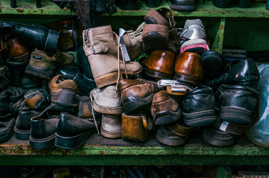 A bunch of old shoes sitting on a shelf