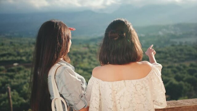 Two asian friend girls exploring the map of Greece. Travel, freedom, friendship, lifestyle concept. Filmed on Sony, 4k, 10 bit color