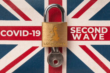 Covid-19 UK lockdown concept: a lock over a union jack flag with the message 