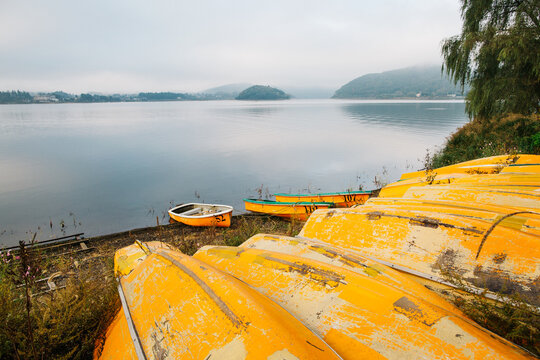 Many Orange Wooden Boats on Lake Shore