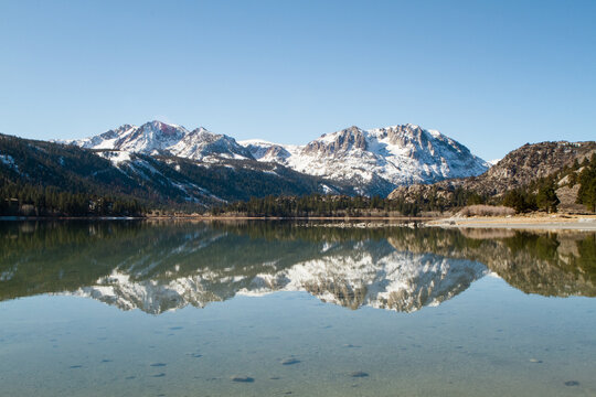 Snowy Mountains Reflecting in Glassy Water