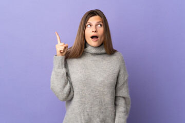 Young Slovak woman isolated on purple background intending to realizes the solution while lifting a finger up