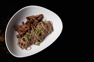 Thai soba salad in white bowl. Stir fry noodles, Soba salad with vegetables and meat.