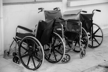Plakat The old wheelchairs are left behind after being used. Not available condition At a medical facility