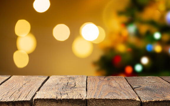 Christmas empty wooden table over christmas tree and blurred light bokeh