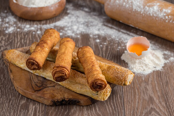 Traditional Turkish Borek or Turkish pastry with minced meat, cheese and spinac on wooden background