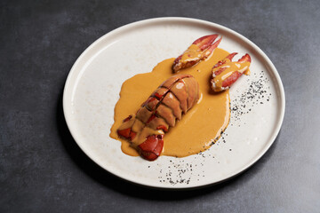 Seafood lobster with soup sauce. Cooked lobster on restaurant table, close-up