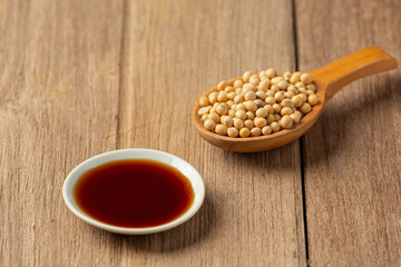 Soybean Sauce and Soybean on Wooden Floor Soy sauce Food nutrition concept.