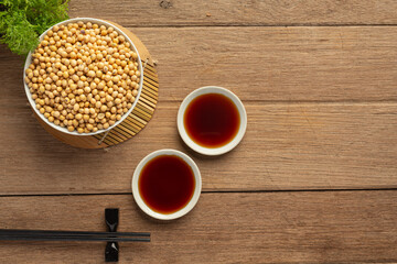Soybean Sauce and Soybean on Wooden Floor Soy sauce Food nutrition concept.