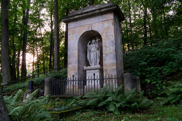 Fototapeta na wymiar Mysterious old forest cemetery in Cesky Raj (Czech Paradise) near Mala Skala, Turnov, Czechia