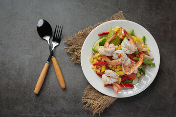 Som Tum with Corn and Shrimp, served with rice noodles and green salad Decorated with Thai food ingredients.