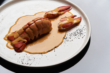 Seafood lobster with soup sauce. Cooked lobster on restaurant table, close-up