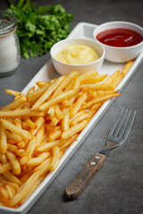 Crispy French fries with ketchup and mayonnaise.