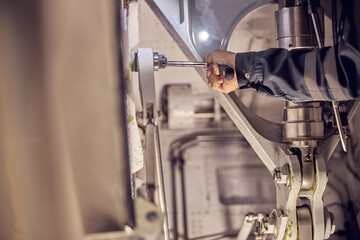 Engineer analyzing airplane part in the indoors