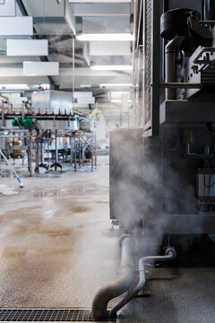 Steam and vapour coming from industrial machine in a factory
