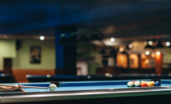 Pool player breaking billiard triangle pyramid