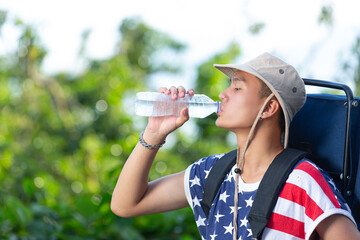 Tourist drinking water from the bottle in the countryside