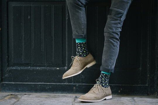 Close up of senior man wearing black jeans and colorful socks