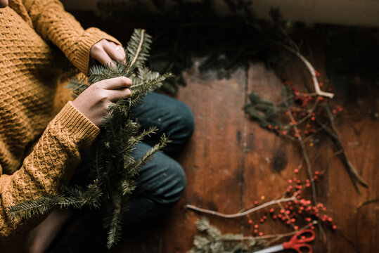 young woman making a wreath