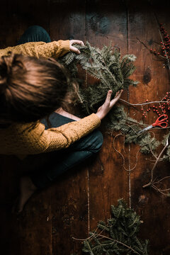 young woman making a wreath