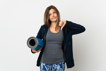 Slovak girl going to yoga classes isolated on white background showing thumb down with negative expression