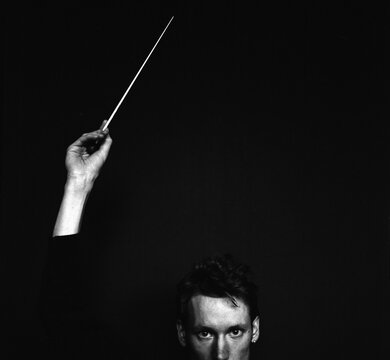 Black and White portrait of a young conductor and his baton
