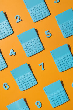 Blue pocket calculators with numbers on orange background.