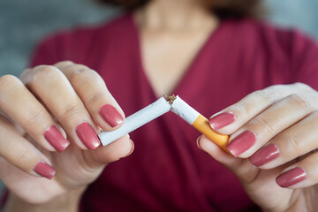 stop smoking concept with woman hand breaking cigarette