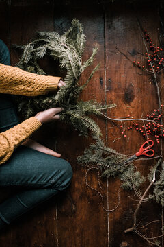 young woman making a wreath