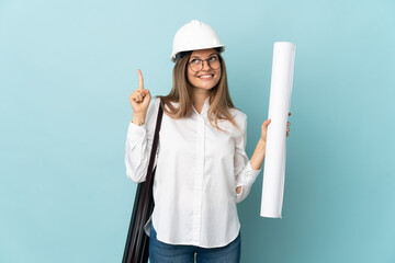 Slovak architect girl holding blueprints isolated on blue background pointing up a great idea