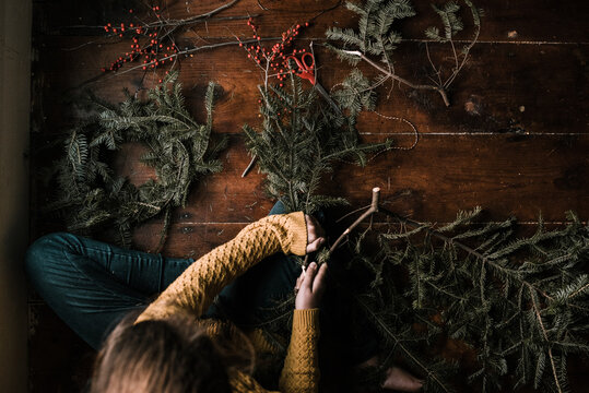 young woman making a wreath