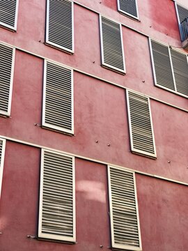 front view of a pastel pink appartment buidling