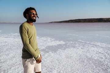 Image of happy african american man smiling while posing in salt valley