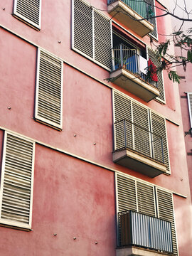 front view of a pastel pink appartment buidling