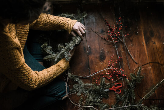 young woman making a wreath