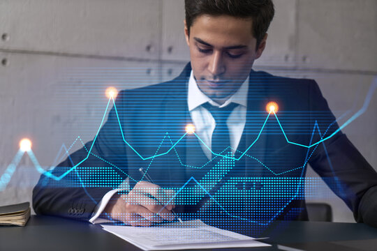 Businessman signs contract and financial chart hologram. Double exposure. Formal wear. Concept of market analysis.