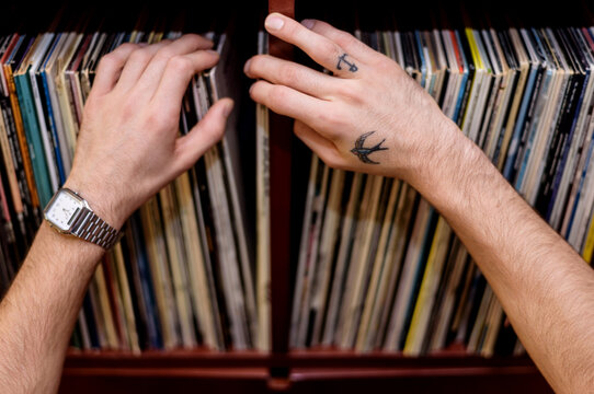 Side view of man racking vinyl records