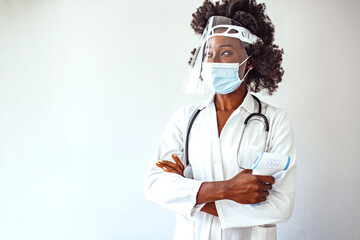 Young female doctor is measuring your body temperature with a digital infrared thermometer. Shot of...