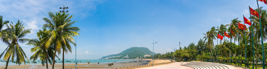 Fototapeta na wymiar park in front beach of Vung Tau city with waves, coastline, streets, coconut trees and Tao Phung mountain in Vietnam