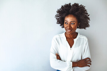 Portrait of a young African ethnicity businesswoman. Businesswoman with arms crossed looking at camera. Confident smiling african american girl with crossed hands on chest