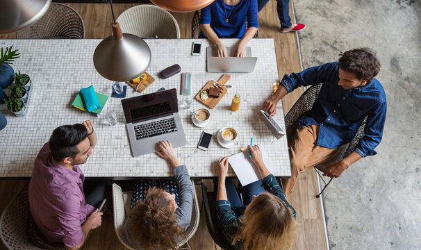 Overhead view of a small group of digital nomads working together